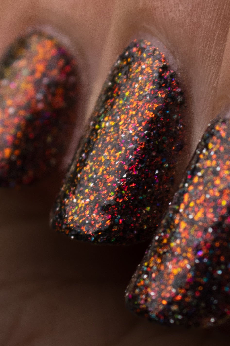 red sparkles with lavender reflective glitter in a dark base over nails