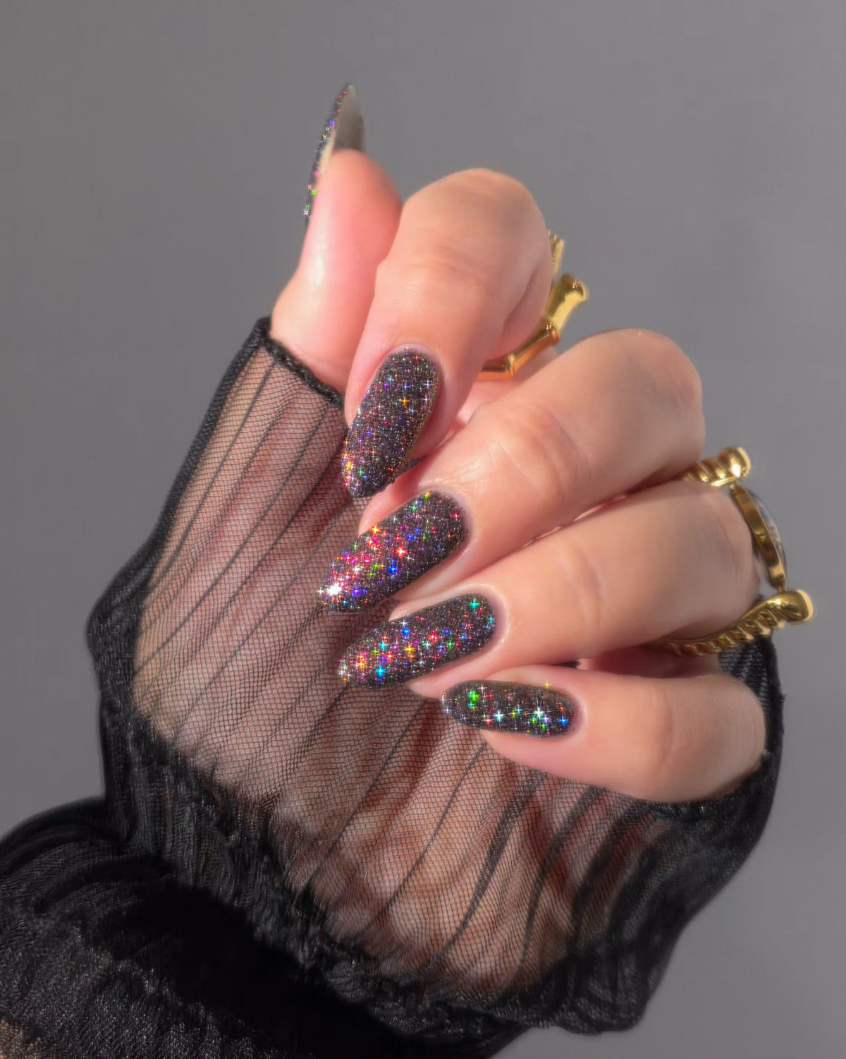 red sparkles with lavender reflective glitter in a dark base over nails 