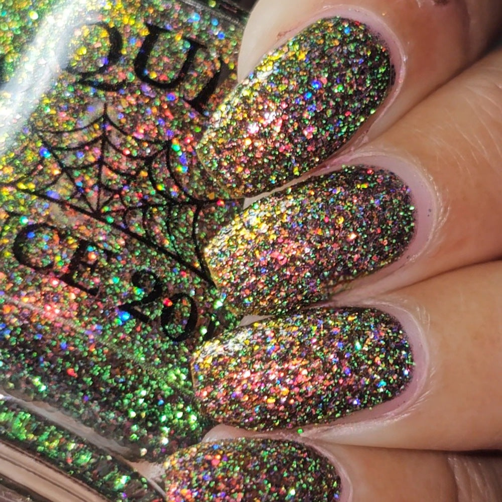 nails painted with sparkly glittery polish showing pink, red, green, gold and orange glitters in a darkened base color