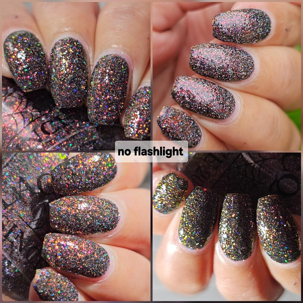red sparkles with lavender reflective glitter in a dark base over nails holding bottle that says LACQUISTRY SINCE 2011 with flash off