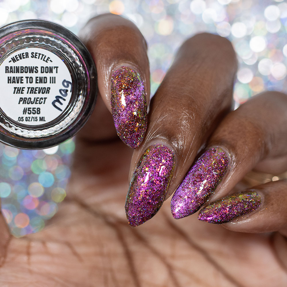 flakie magnetic polish showing red, orange, gold, green flakes, holo glitter, and magnetic effect of fuchsia to purple