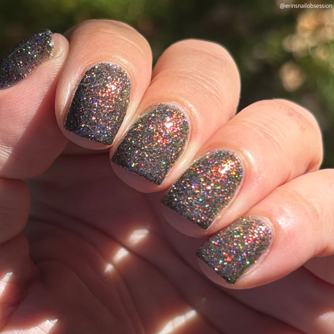 red sparkles with lavender reflective glitter in a dark base over nails