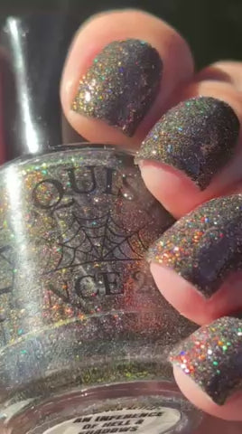 video in the sun of red sparkles with lavender reflective glitter in a dark base over nails holding bottle that says LACQUISTRY SINCE 2011